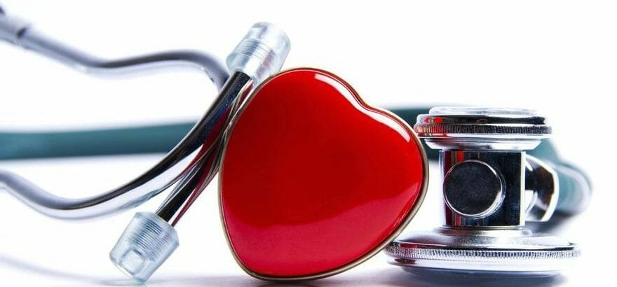 close up of a stethoscope wrapped around a heart pin